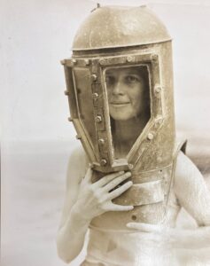 Gloria Anable poses in a diving helmet